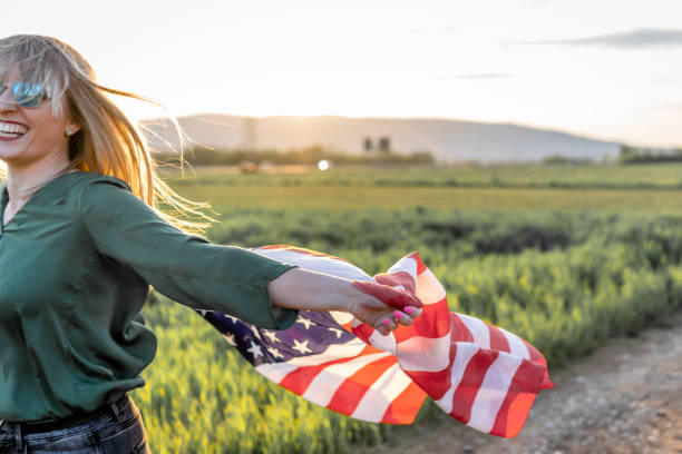 istock Woman flying American Flag 1396742702