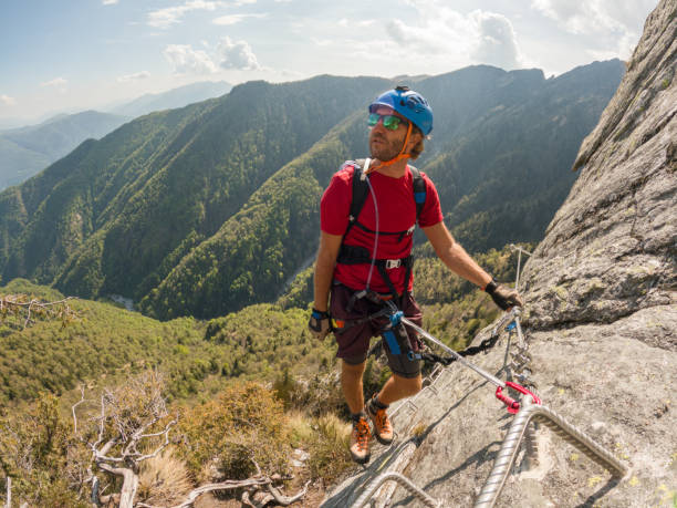 istock Young man climbs via ferrata rock face 1396742743