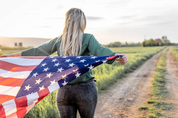 istock Woman flying American Flag 1396742746