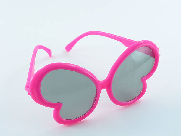 Pink Butterfly Sunglasses A pair of kids sunglases in a butterfly shape. cool glasses hand colored sun stock pictures, royalty-free photos & images