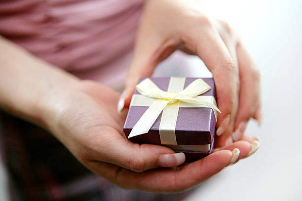 istock Close-up of a small gift box with bow in a woman's hands 139674774