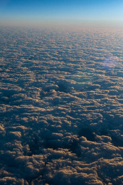 istock Sunrise paints the clouds from above. 1396747915