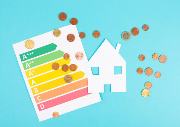 Paper house and Euro coins, power consumption grafic, increasing heating costs, green technology, inflation, social and financial issue stock photo
