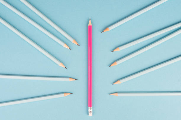 istock Blue pencils point to the pink one, standing out from the crowd concept, be different, leadership, mobbing issue 1396749748