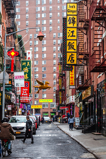 New York City, USA - A few people in the street in Chinatown district.