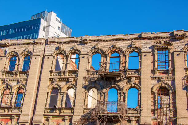 Ruined old brick building with broken windows overlooking the sky.