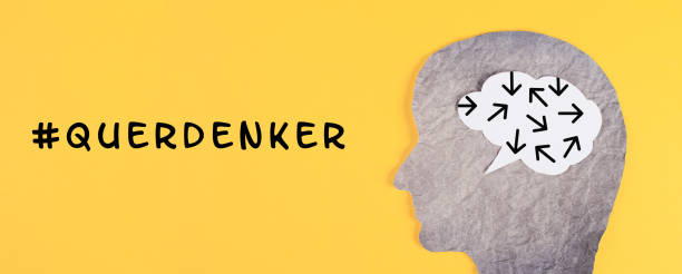 istock Think different stands in german language on the yellow background, head with brain, being a nonconformist, standing out from the crowd, conspiracy theory 1396750929
