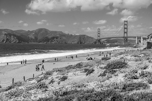 Sunny windy day with waves and bay in background, at Baker beach.