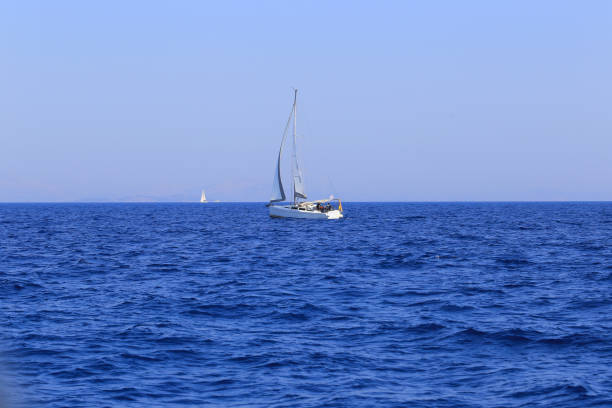 Sailing yacht on the sea horizon in Greece