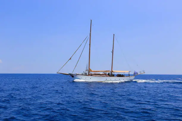 Sailing yacht on the sea horizon in Greece
