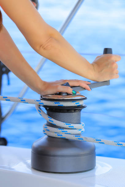 istock Yachtsman hand dealing with yacht ropes on halyard winch 1396755831