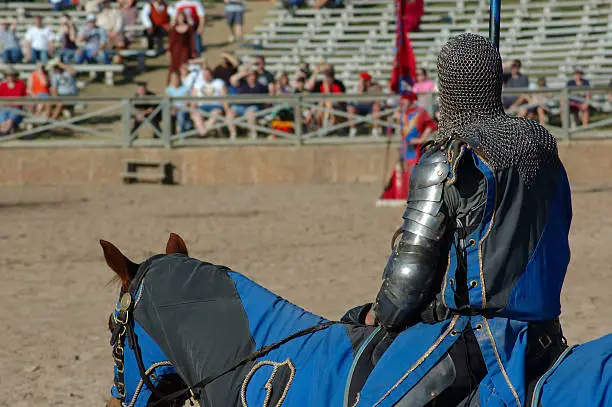 A knight awaits the joust on his horse.