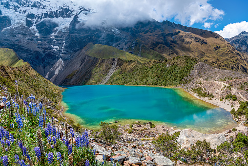 Humantay Lake,  Cusco, Peru - May 9, 2022;  The Humantay Lake  is located about 75 miles to the northwest of Cusco and just south of Machu Picchu. The lake can be found between Humantay Mountain and Salkantay Mountain.  Humantay Lake is most well known for its bright blue water. This colour comes from the mineral-filled runoff from the melting glaciers around the Humantay and Salkantay Mountains.