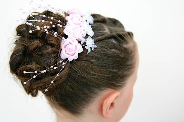 Photo of a child with her hair done pretty for a wedding.