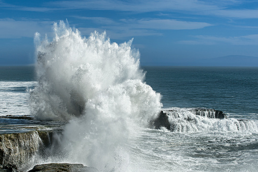 Surfers in the sea at Porthcurno, Cornwall.