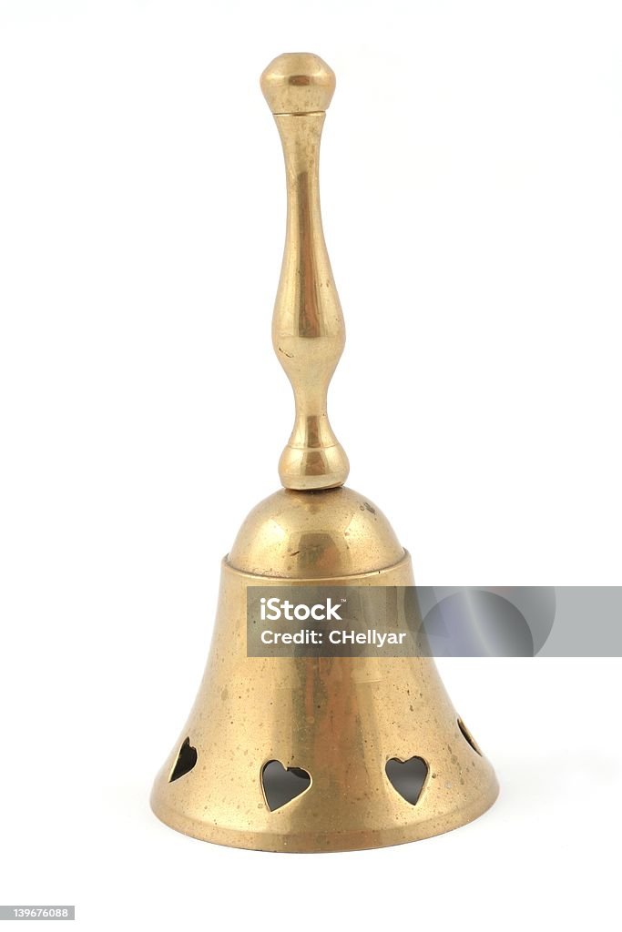 Brass Handbell A slightly used looking brass hand bell, isolated on a white background. Bell Stock Photo