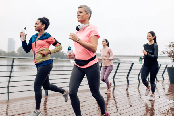 istock Female running team training on a rainy day 1396761319