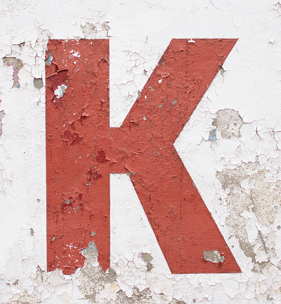 The letter K is red on a white background