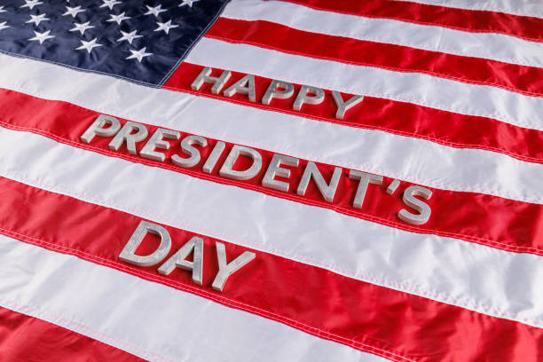 istock words happy presitdents day laid with real letters on US flag surface 1396761630