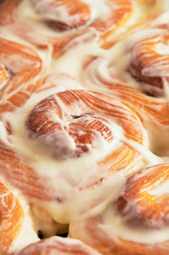 Homemade cinnabons in baking dish are taken out of the oven. Front view.