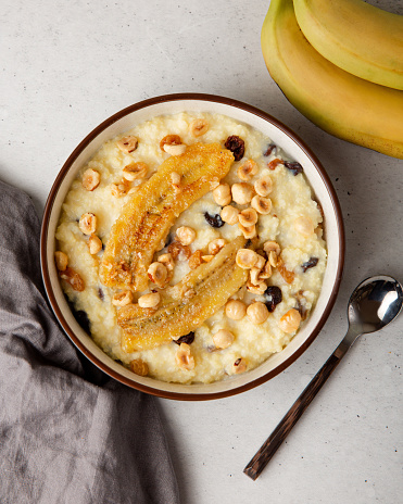 Millet porridge in the bowl with fruits and nuts. Above