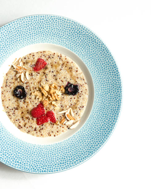 Quinoa porridge with coconut milk in plate. Top view.