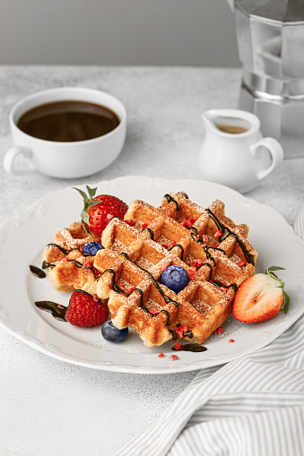Belgium waffles with berries and morning coffee.