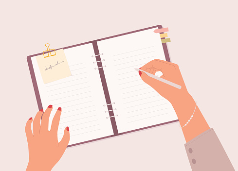 Businesswoman’s Hand With Pen Writing On A Empty Space Notebook With Hardcover Ring Binder. Isolated On Color Background.