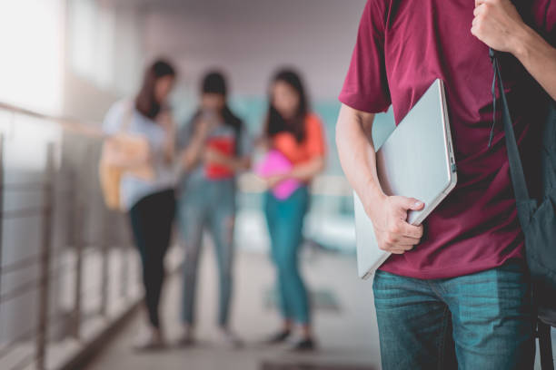 istock A man asian students standing with holding laptop in university, happy education communication communicate. 1396767487