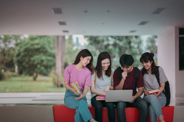 istock Asian group of student using laptop, digital tablet together. Lifestyle with information technology gadget education or social network concept. 1396767504