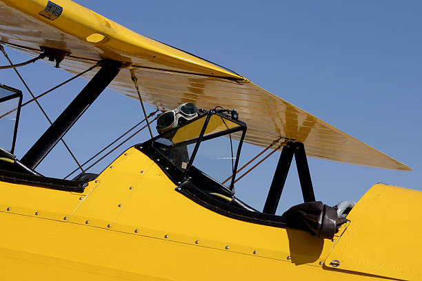 Yellow Biplane Cockpit with Flight Goggles and Bomber Jacket stock photo