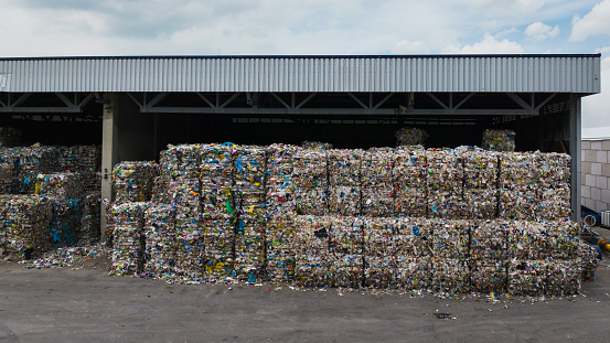 Plastic Waste - Crushed Plastic Garbage Recyling Storage Depot. Compressed Plastic Garbage Bales in Storage Depot, ready for a Recycling Process. Waste Management - Recyling in Germany, Europe.