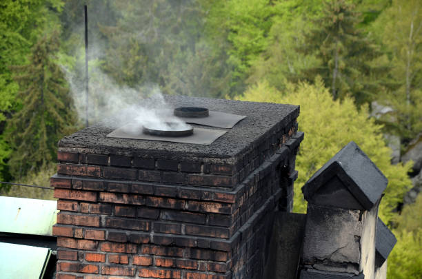 a dirty chimney in which coal is heated. soot is everywhere on the brick masonry. in the spring in the woods at the cottage. victorian style. ecological way of heating houses and flats - chimney sweeping imagens e fotografias de stock