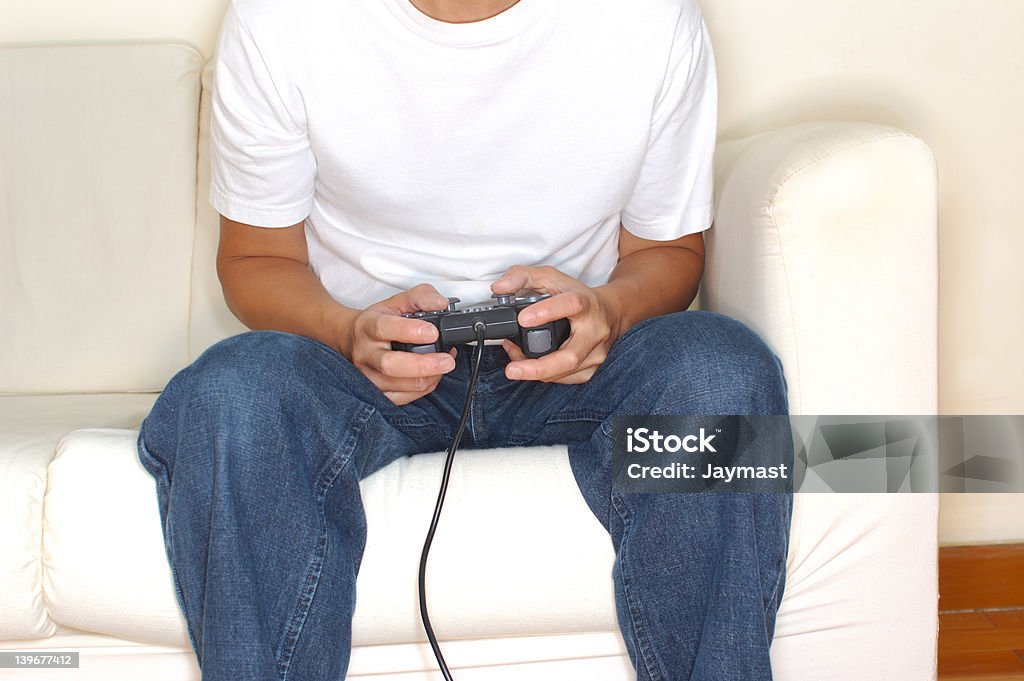 Video game Person playing videogames alone in bright room. Addiction Stock Photo