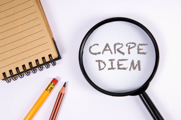 istock Carpe Diem. Latin phrase. Magnifying glass on a white background 1396779159