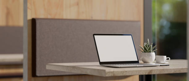 istock Modern co-working space with opened laptop mockup on the table. 1396783660