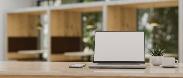 istock Modern workspace with laptop mockup over blurred cafe co-working space in background. 1396783661