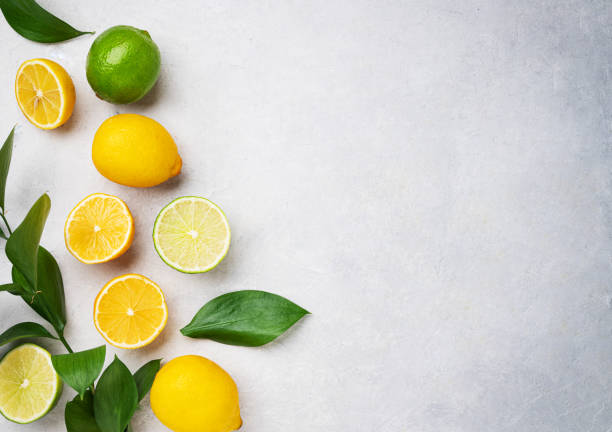 istock Fresh lemons and limes on a blue textured background. Citrus fruit concept for freshly squeezed lemonade. Top view and copy space 1396784483