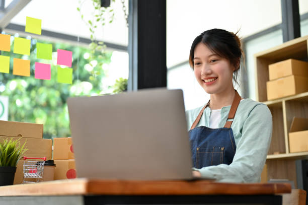 istock Female fashion shop owner using laptop computer to reply message from her customer 1396784595
