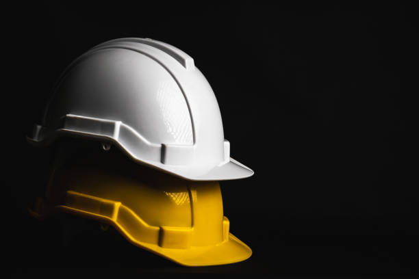 istock Safety helmet engineer white and yellow on black background 1396789072