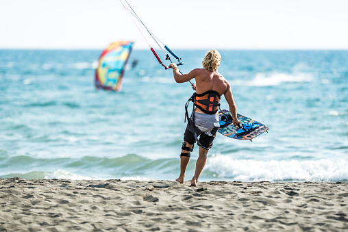 Kiteboarding, Kitesurfing. Water Sports. Professional Kite Surfer In Action On Waves In Ocean. Extreme Sport. Healthy Active Lifestyle. Hobby. Recreational Sporting Activity. Summer Fun, Adventure