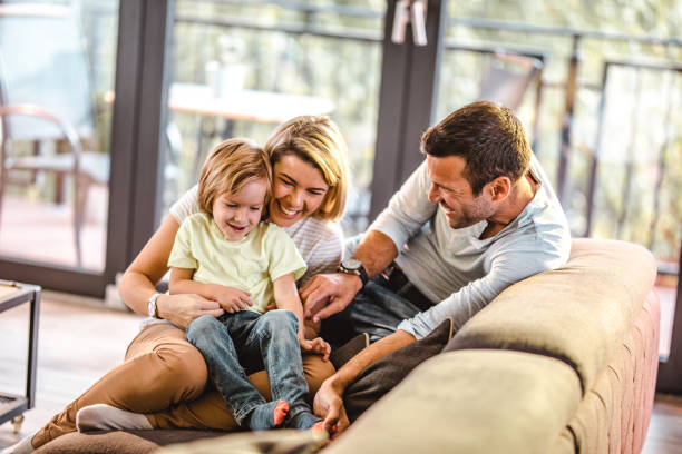 istock Cheerful parents having fun with their small boy at home. 1396791829
