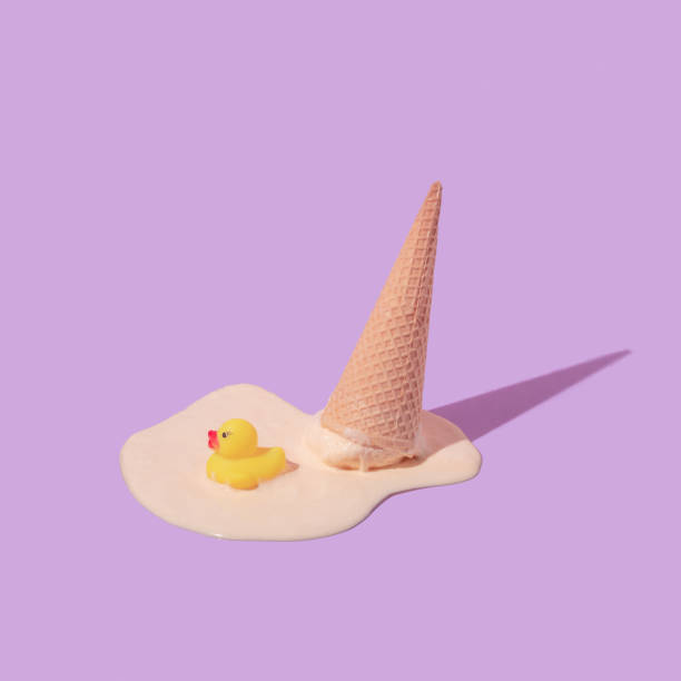 istock Summer creative layout with melting ice cream cone upside down and rubber duck toy on pastel purple background. 80s or 90s retro fashion aesthetic ice cream concept. Minimal summer idea. 1396791917