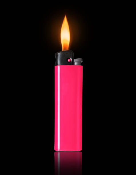 istock Pink lighter with a burning flame on a black background 1396793106