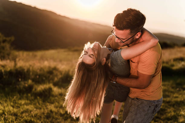 istock Happy couple in love dancing during springtime at sunset. 1396793114
