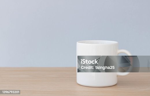 istock The white ceramic coffee mug is placed on a wooden table. Perfect for businesses selling mugs or coffee cafes, just overlay your quote or design onto the image. 1396793201