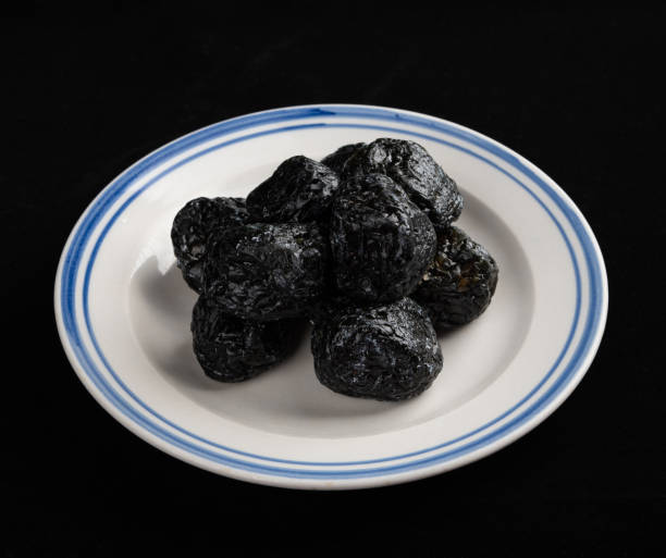 istock Chinese Smoked Plum on Black Background 1396793223