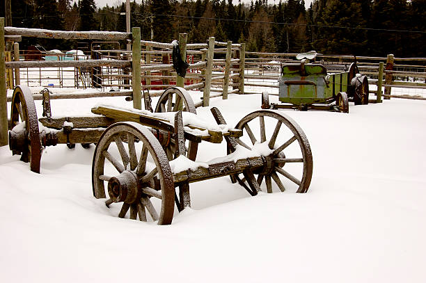 Wintery Farmyard Ranch with old machinery stuck in the snow drifts covered wagon horse cart snow winter stock pictures, royalty-free photos & images