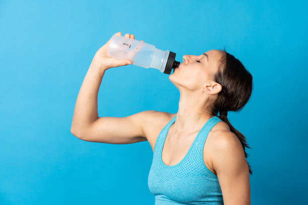 istock Hispanic fit woman drinking water 1396795122
