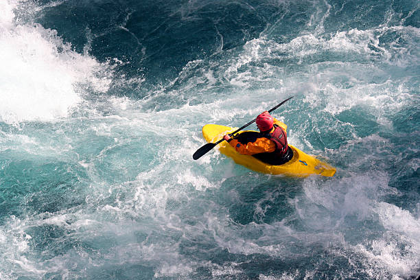 Kayaker maneuvers over rough waters  a kayaker extreme sports stock pictures, royalty-free photos & images